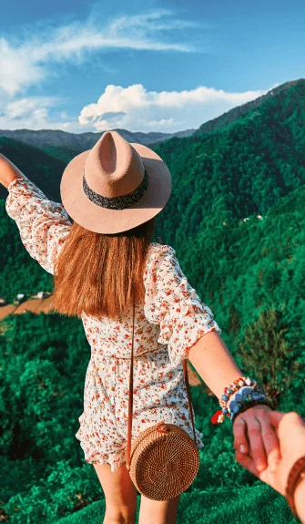 Woman exploring lush green mountains – Fab Holidays, the best travel agency in Delhi.