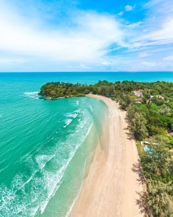 Aerial view of a tropical beach with turquoise waters and lush greenery in Thailand – Fab Holidays, best travel agency in Delhi