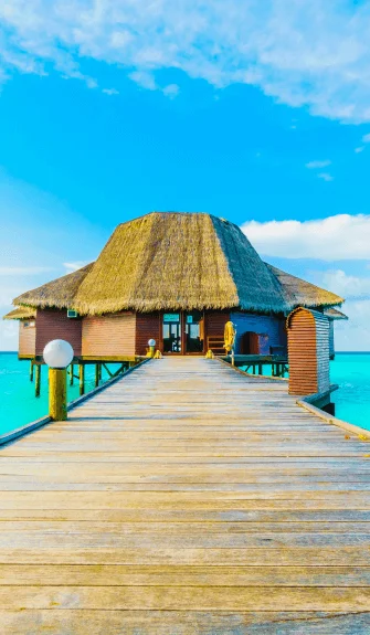 Overwater villa with turquoise sea and clear skies – Fab Holidays, the best travel agency in Delhi.