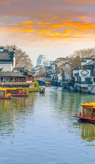Traditional boats on a scenic canal at sunset – Fab Holidays, the best travel agency in Delhi.
